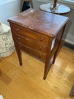 Front and top view showing three drawers and finish wear