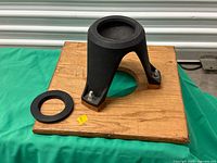 Angle view of hi-hat mounted on wooden board with adapter ring alongside