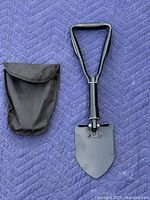 Shovel opened beside nylon pouch