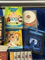 Family Guy DVDs, Poltergeist Blu-ray, loose discs