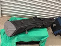 Full view of black Manfrotto tripod bag lying horizontally