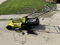 Full mower with bag, battery and charger displayed on ground