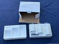 Open box, styrofoam insert and three LED candles laid out