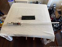 Lightsaber with display mount laid on table