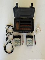 Entire kit laid out: transmitter, receiver, antennas, cables, power supply, Pelican case