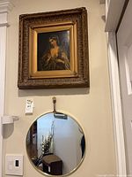 Painting and mirror displayed on wall