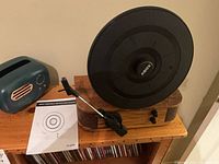 Front view of ABox vertical turntable, tissue box cover and manual
