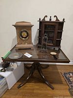 Group shot of clock, table, shelf and ornament