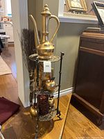 Full view of brass 3-tier stand with contents