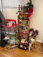 Full lot with shelf of ornaments, nutcracker statue, storage bins of lights and ornaments
