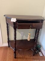 Front view showing hall table, drawer, turned legs, lower shelf