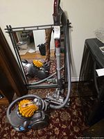 Full view of Dyson DC23 canister vacuum with hose and wand