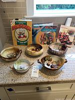 Overall lot showing four porcelain bowls and three cookbooks
