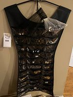 Full view of dress-shaped organizer filled with costume jewelry