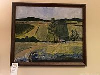 Front view of framed landscape painting on wall