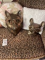 Front view of fox and mouse plaques showing finish and eyewear