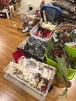 Overview of multiple totes filled with stockings, ornaments, garlands and decor