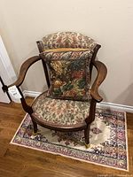 Front view of chair on rug with pillow displayed