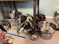 Full view of assorted cookware under table