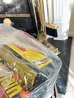 Brass fireplace tools and firelogs near hearth