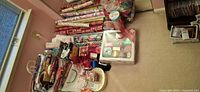 Wide view showing rolls of wrapping paper, ribbon bin, gift bags and bows