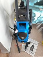 Full view of Pacific Hydrostar pressure washer with hose, power cord, spray gun, wand and manual visible