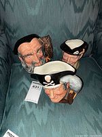 All three Royal Doulton jugs grouped together on chair