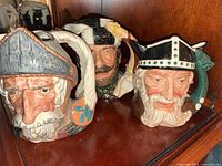All three Royal Doulton Toby Jugs on shelf