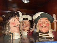 Front view of all three Musketeer Toby jugs on shelf