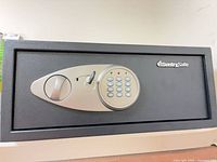 Front view of SentrySafe showing electronic keypad, handle, and key inserted