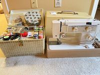Elgin sewing machine, hard case, sewing basket with contents