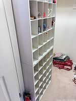 Full view of stacked white cubby units showing overall height and multiple compartments