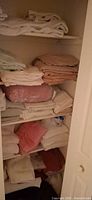 Overall view of closet with towels and sheets