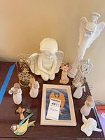 Group view of all angel figurines, ornaments, framed print