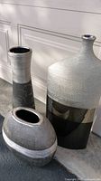 Three vases grouped to show relative sizes, finishes and openings