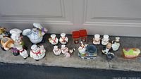 Line-up of all 18 chef themed ceramic items on driveway