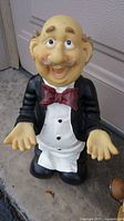 Front view of standing butler figurine