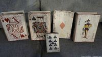 Front view showing all five playing-card book boxes on couch