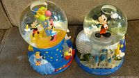 Both Disney snow globes side by side