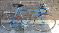 Full drive-side view of blue Dino road bike
