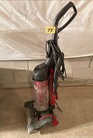 Full view of upright vacuum with handle and cord