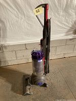 Full view of Dyson upright vacuum standing on floor