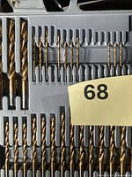 Overall view of drill bit set showing numeric and lettered bits in case