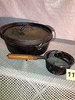 Dutch oven with lid and small saucepan side by side