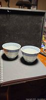 Two blue and white rice grain porcelain cups upright