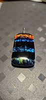 Front view of rectangular dichroic glass pendant showing multi-colour bands