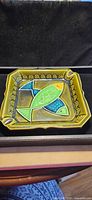 front view of ceramic ashtray displaying fish design and rim