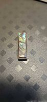 Front view of rectangular paua shell sterling silver pendant