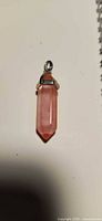 Front view of pink quartz pendant showing cap and bail