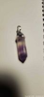 Front view of fluorite point pendant showing color banding and cap